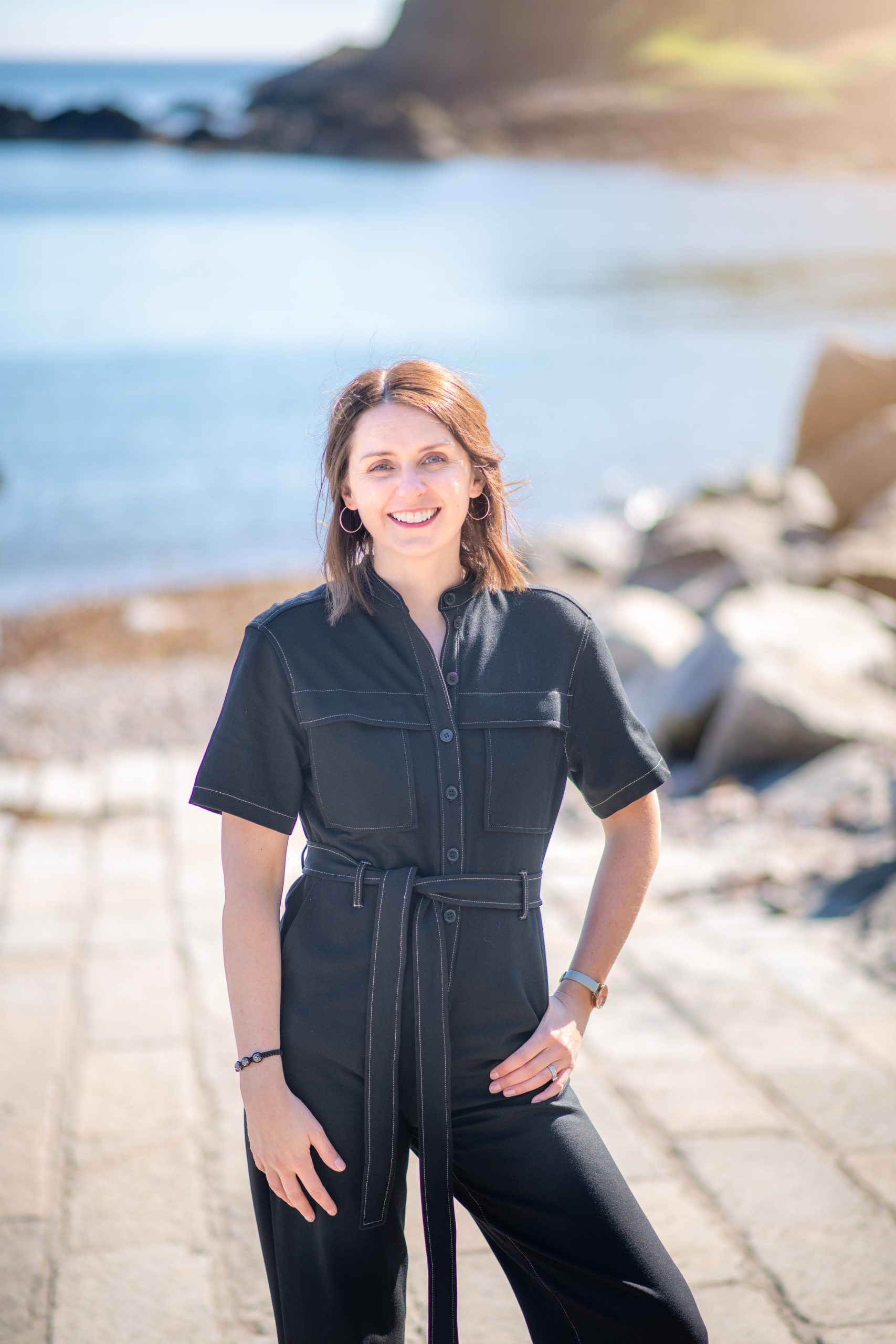 IVC_2982-Edit Woman standing on a jetty on the beach